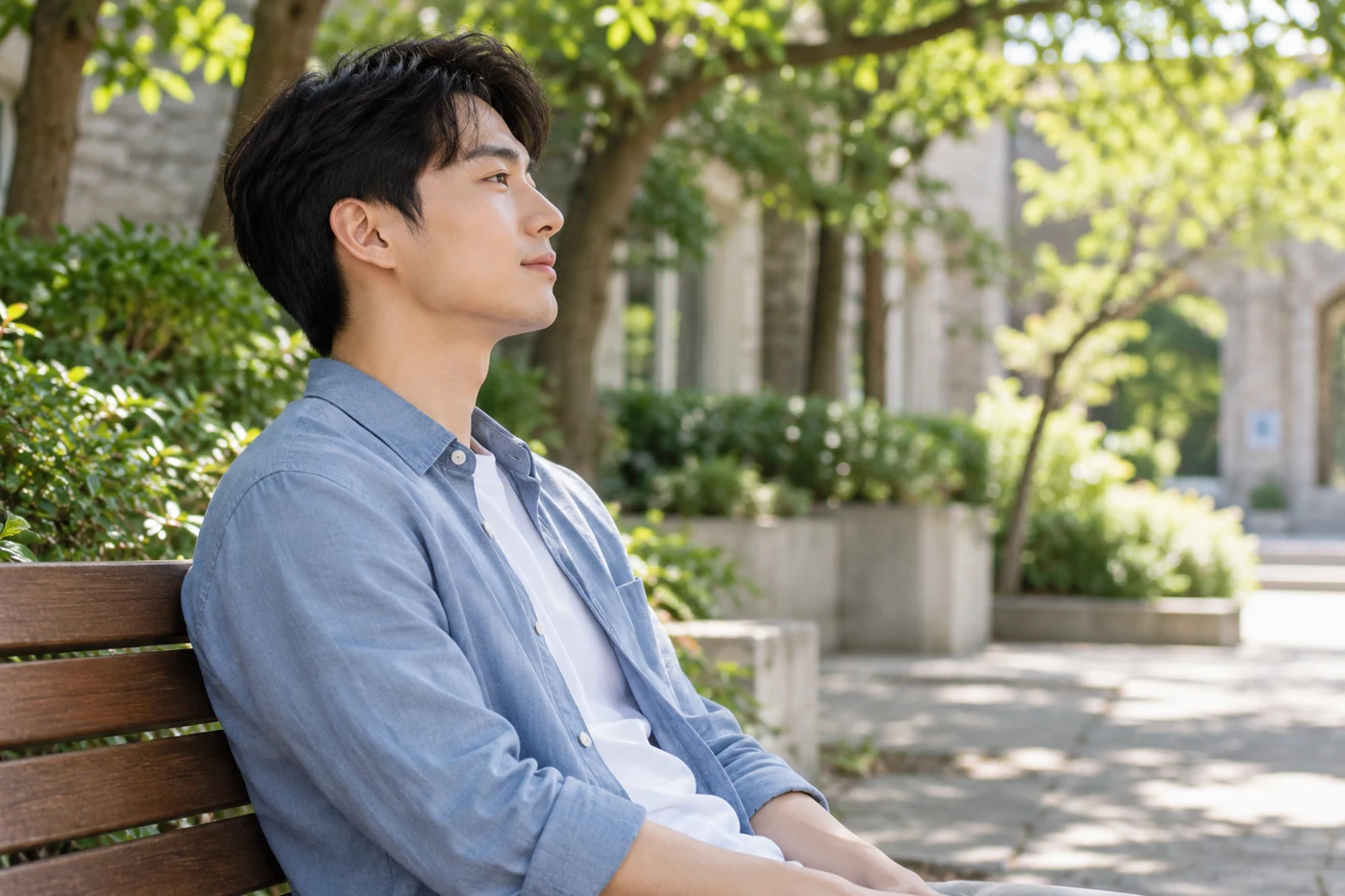 A seated adult breathing comfortably in a quiet outdoor courtyard.